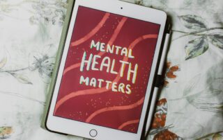 iPad with screensaver saying Mental Health Matters background