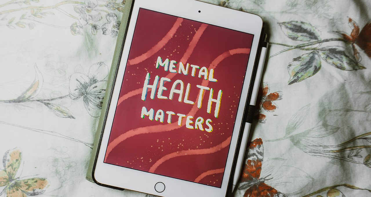 iPad with screensaver saying Mental Health Matters background